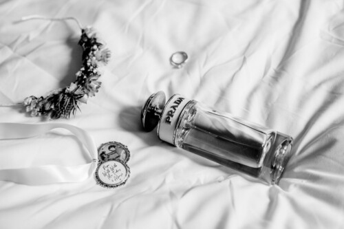 Hochzeitsfotograf Berlin Prada Parfum und Haarschmuck auf Bett liegend